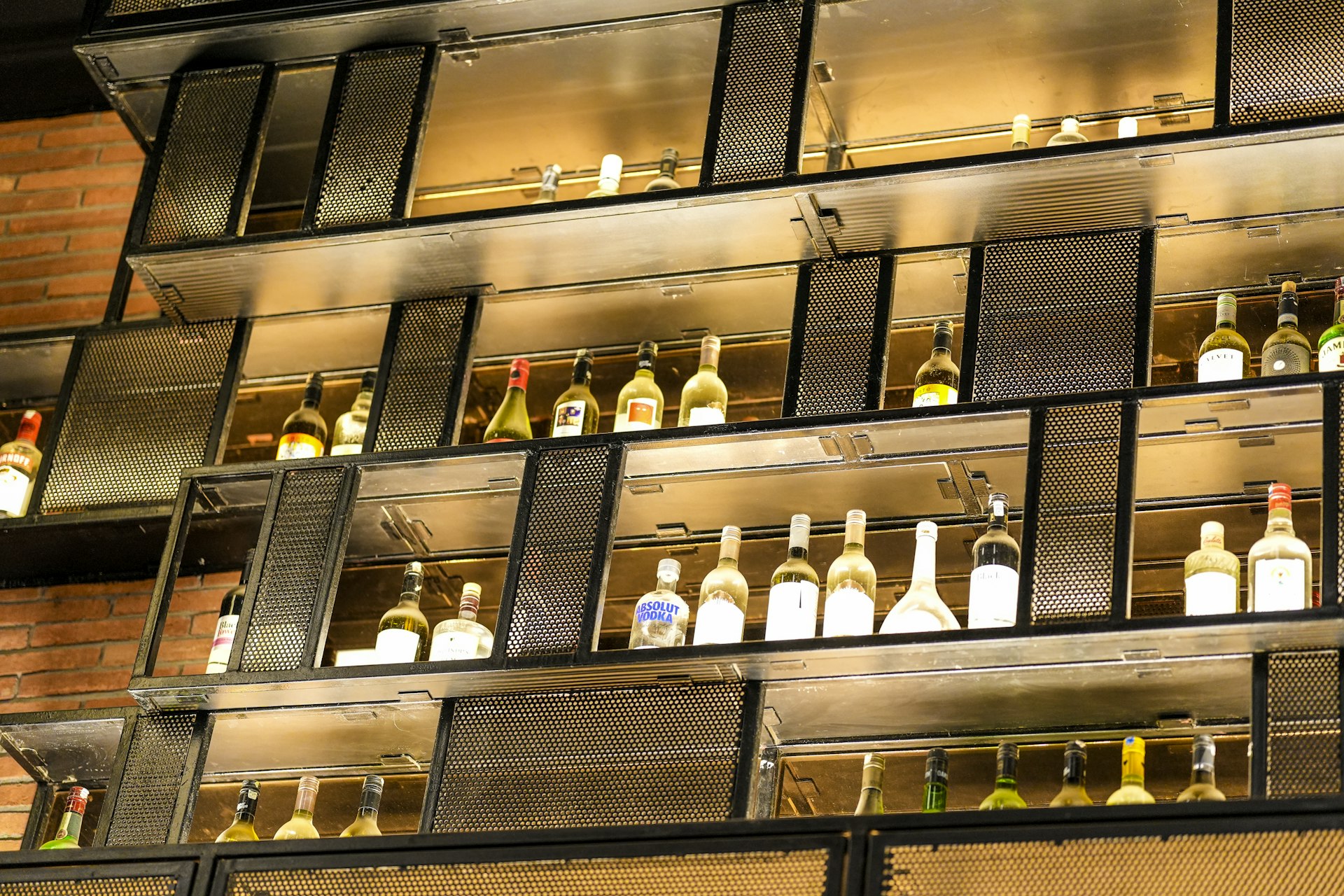 Bottles of wine displayed on shelves in a bar