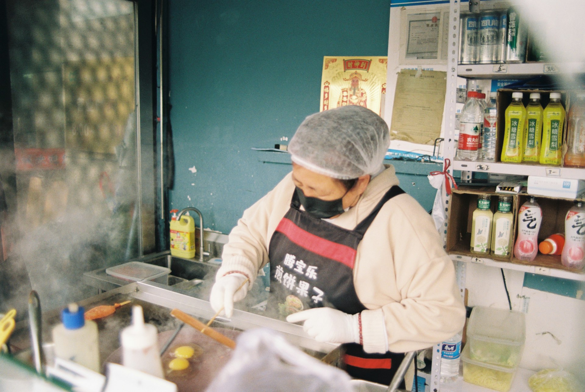 A cook prepares food behind a counter